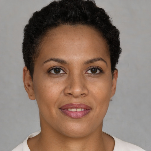Joyful black young-adult female with short  brown hair and brown eyes