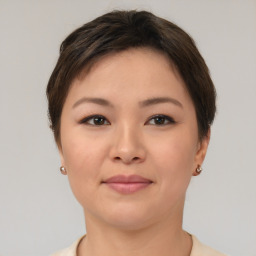 Joyful asian young-adult female with short  brown hair and brown eyes