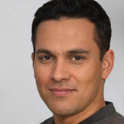 Joyful white adult male with short  brown hair and brown eyes