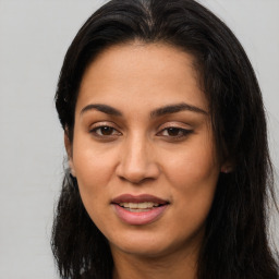 Joyful latino young-adult female with long  brown hair and brown eyes