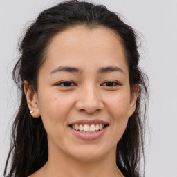 Joyful asian young-adult female with long  brown hair and brown eyes