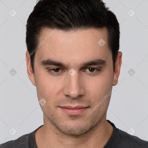 Joyful white young-adult male with short  black hair and brown eyes