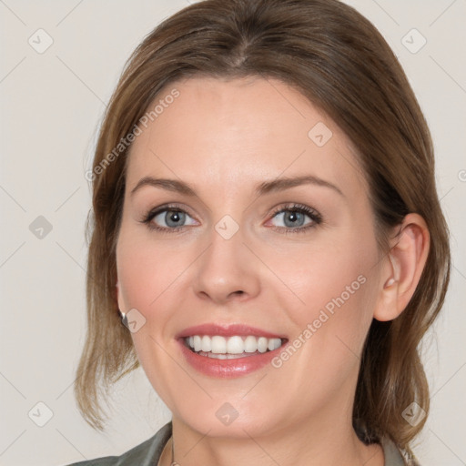 Joyful white young-adult female with medium  brown hair and blue eyes