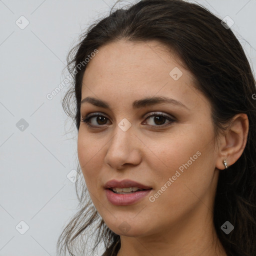 Joyful white young-adult female with long  brown hair and brown eyes