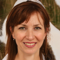 Joyful white adult female with medium  brown hair and brown eyes