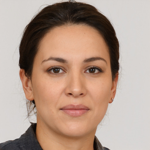 Joyful white adult female with medium  brown hair and brown eyes