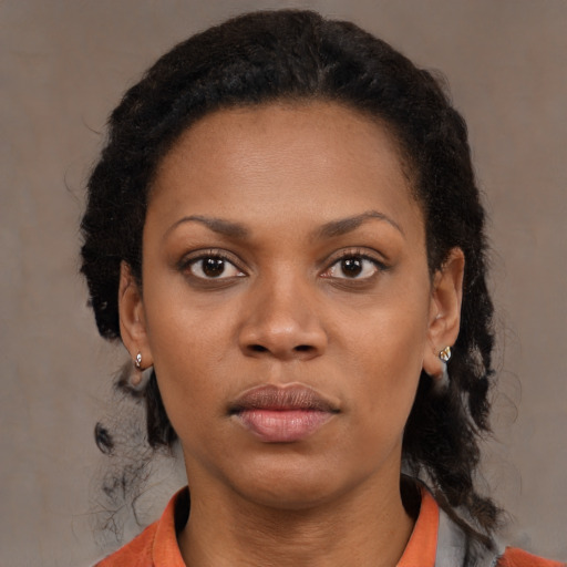 Neutral black young-adult female with medium  brown hair and brown eyes