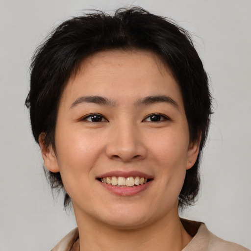 Joyful asian young-adult female with medium  brown hair and brown eyes