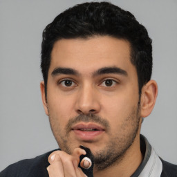 Neutral latino young-adult male with short  black hair and brown eyes