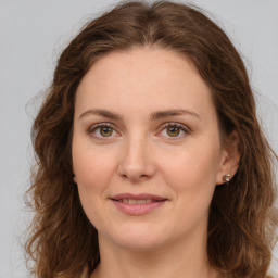 Joyful white young-adult female with long  brown hair and green eyes