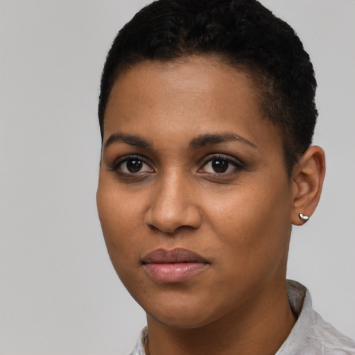 Joyful black young-adult female with short  black hair and brown eyes