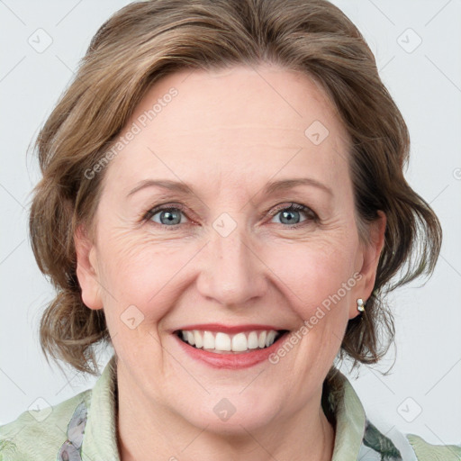 Joyful white adult female with medium  brown hair and grey eyes