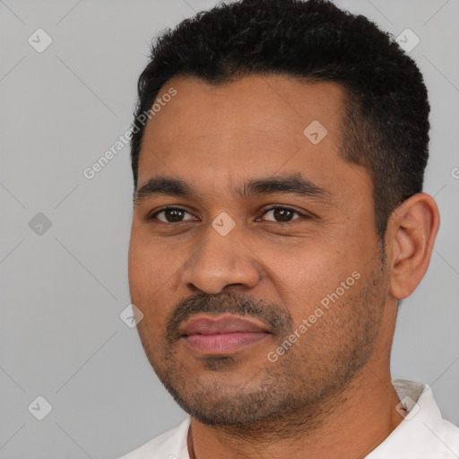 Joyful latino young-adult male with short  black hair and brown eyes