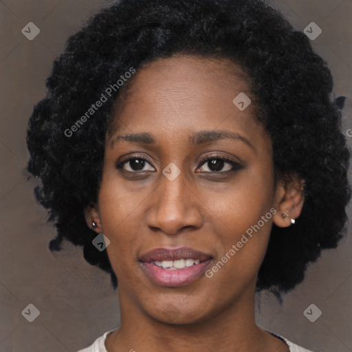 Joyful black young-adult female with short  black hair and brown eyes