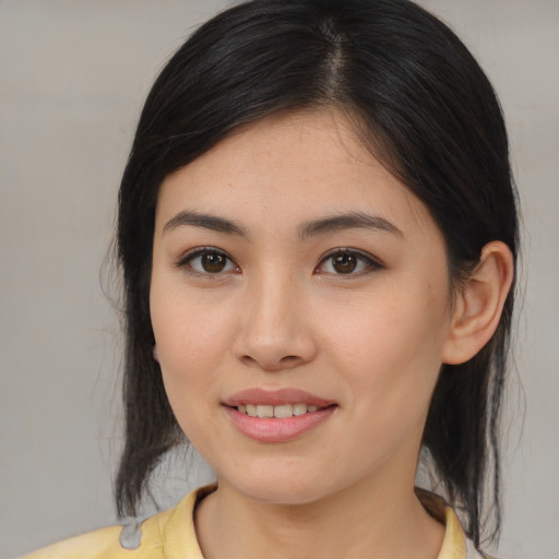 Joyful asian young-adult female with medium  brown hair and brown eyes