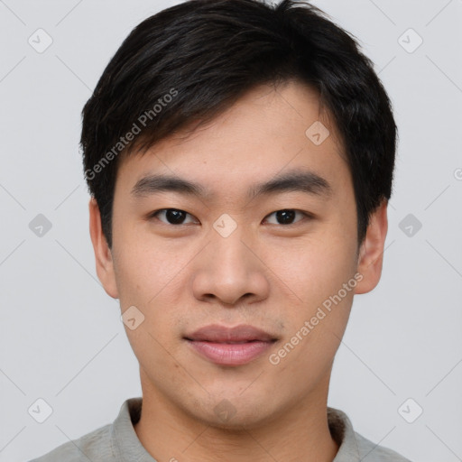 Joyful asian young-adult male with short  black hair and brown eyes