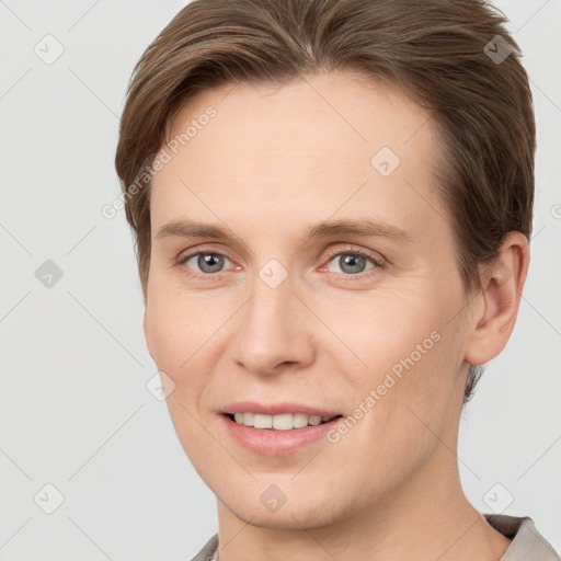 Joyful white young-adult female with short  brown hair and grey eyes