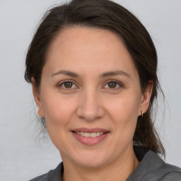 Joyful white adult female with medium  brown hair and brown eyes