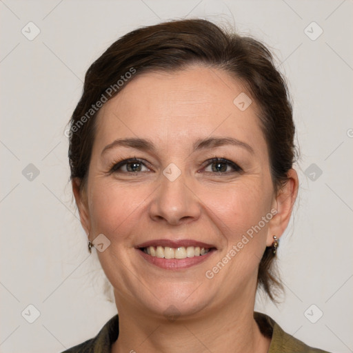 Joyful white adult female with medium  brown hair and grey eyes