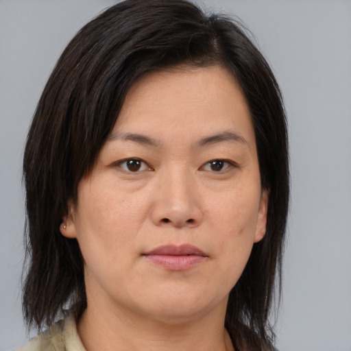 Joyful asian young-adult female with medium  brown hair and brown eyes