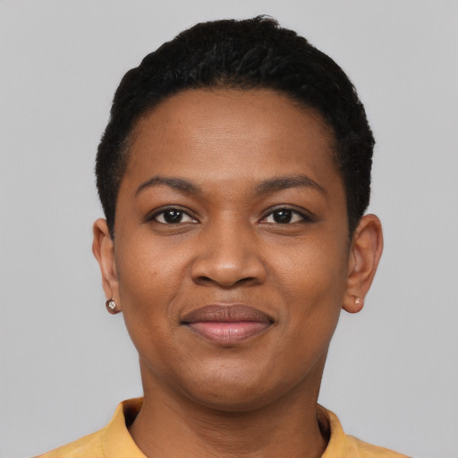 Joyful black young-adult female with short  black hair and brown eyes