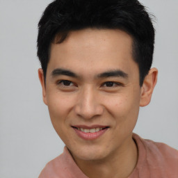 Joyful asian young-adult male with short  black hair and brown eyes