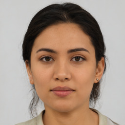 Joyful latino young-adult female with medium  brown hair and brown eyes