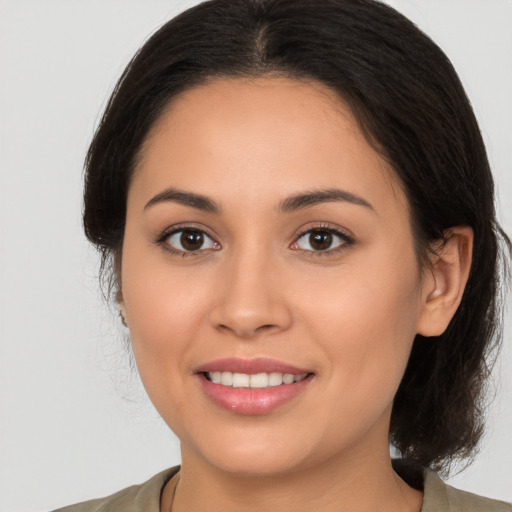 Joyful white young-adult female with medium  brown hair and brown eyes