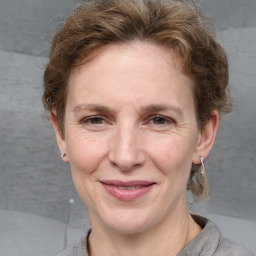 Joyful white adult female with medium  brown hair and grey eyes