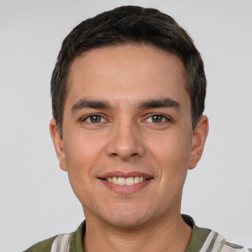 Joyful white young-adult male with short  brown hair and brown eyes