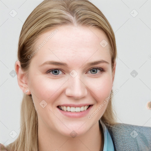 Joyful white young-adult female with long  brown hair and blue eyes