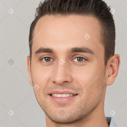 Joyful white young-adult male with short  brown hair and brown eyes