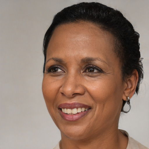 Joyful black adult female with short  brown hair and brown eyes