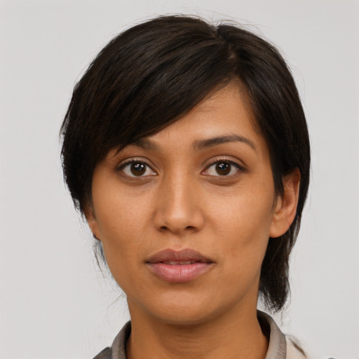Joyful asian young-adult female with medium  brown hair and brown eyes
