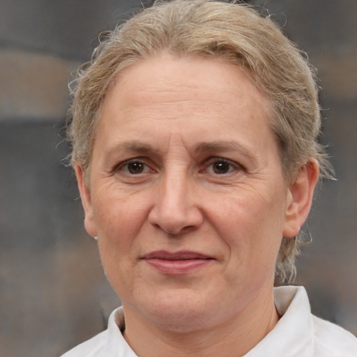 Joyful white middle-aged female with medium  brown hair and brown eyes