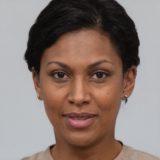 Joyful black adult female with short  black hair and brown eyes