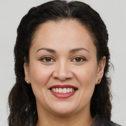 Joyful white adult female with long  brown hair and brown eyes