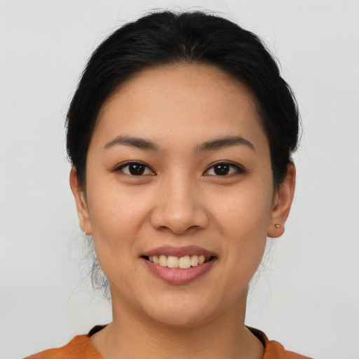 Joyful asian young-adult female with short  brown hair and brown eyes