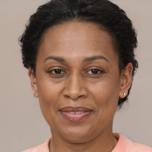 Joyful latino adult female with short  brown hair and brown eyes