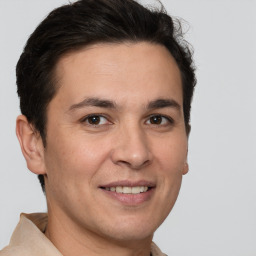 Joyful white adult male with short  brown hair and brown eyes