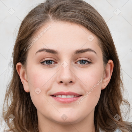 Joyful white young-adult female with long  brown hair and blue eyes