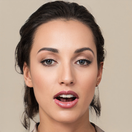 Joyful white young-adult female with medium  black hair and brown eyes