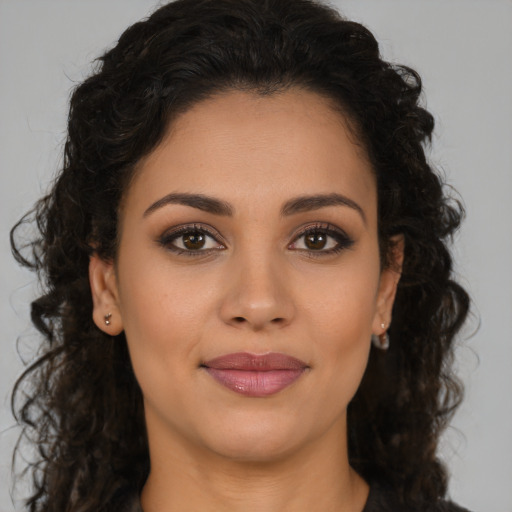 Joyful latino young-adult female with medium  brown hair and brown eyes