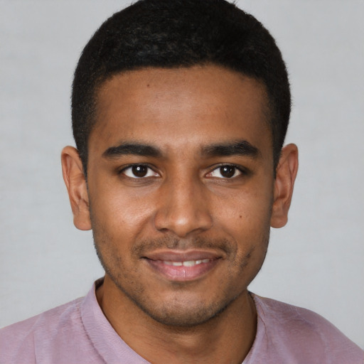 Joyful black young-adult male with short  black hair and brown eyes