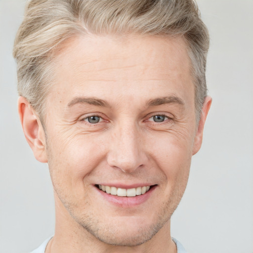 Joyful white adult male with short  brown hair and grey eyes