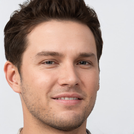 Joyful white young-adult male with short  brown hair and brown eyes