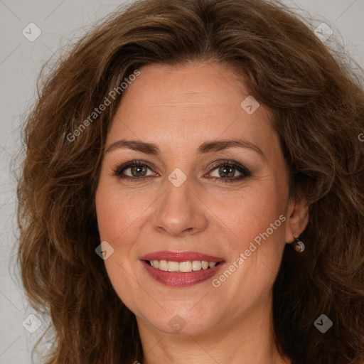 Joyful white adult female with long  brown hair and brown eyes