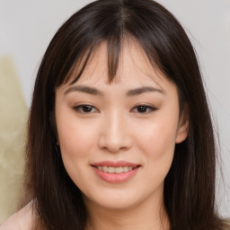 Joyful asian young-adult female with long  brown hair and brown eyes