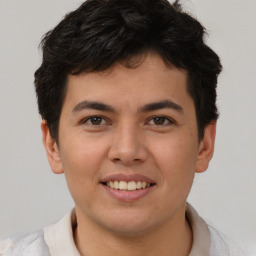 Joyful latino young-adult male with short  brown hair and brown eyes