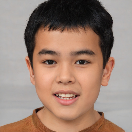Joyful asian child male with short  brown hair and brown eyes
